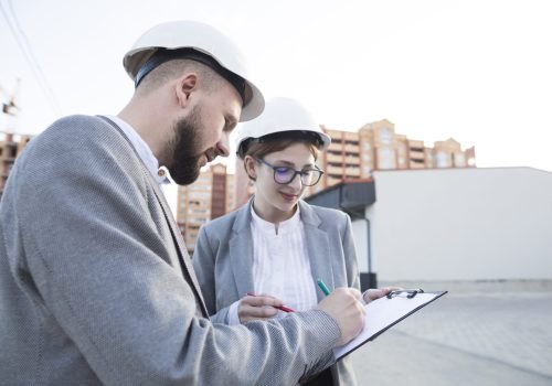 close-up-two-architect-working-together-construction-site
